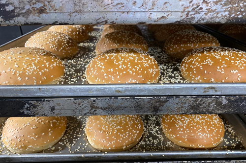 hamburger buns on a metal rack