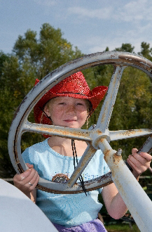 Young Girl on tractor - Photo courtesy of Montana Office of Tourism.