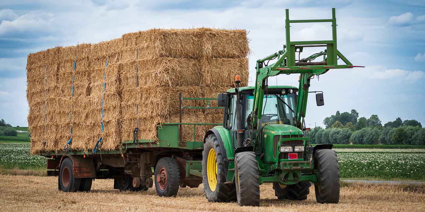 Tractor pulling hay trailer