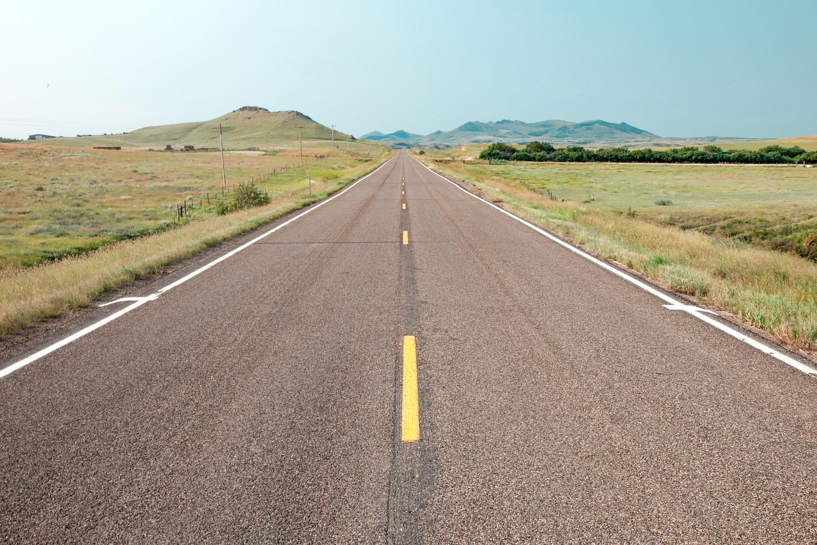 A rural road into the Bear Paw Mountains south of Havre, Montana - photo by Todd Klassy