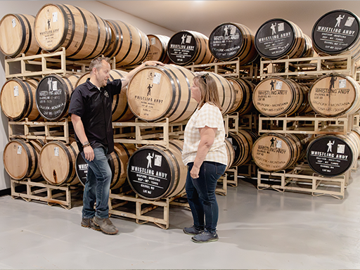 Director Clark visits with Head Distiller at Whistling Andy Distillery 