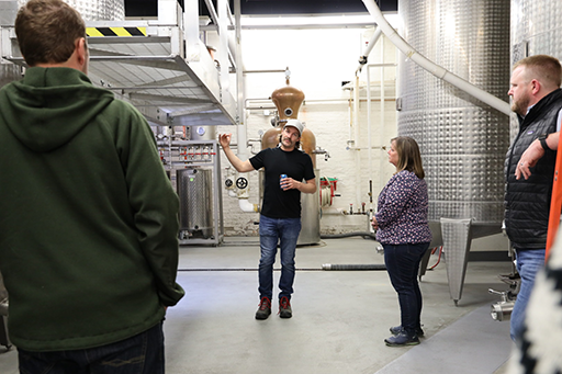 Director Clark listening to owner and distiller of Montgomery Distillery.png