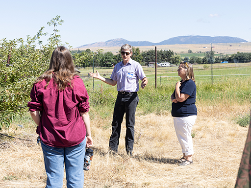 Director Clark hears from Western Cider Co-Founder, Michael Billingsly, at their orchard in Stevensville, Montana